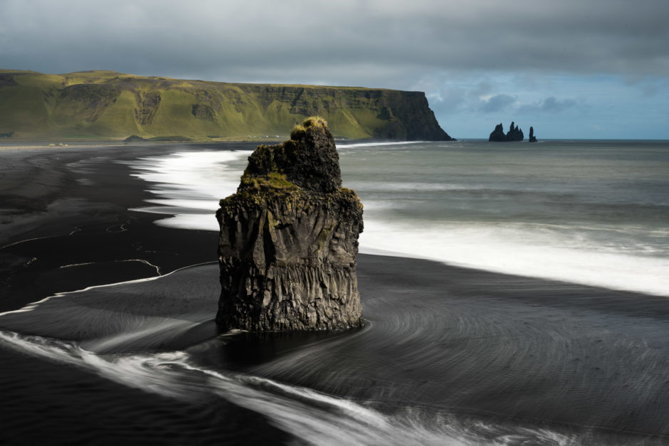 Basalt sea stack on a black sand beach